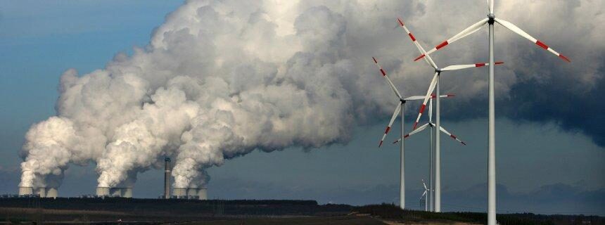 Wind turbines in front of a power plant